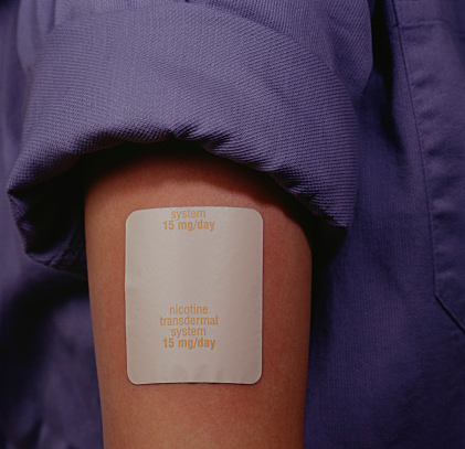 Man wearing nicotine patch, Close-up of arm, mid section